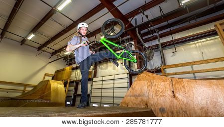 Man Jumping And Riding On A Bmx Bicycle At An Extreme Sports Park