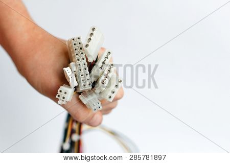 Hand Holds Power Cables From Power Supply Unit On White Background, Pc Motherboard Power Cables And 