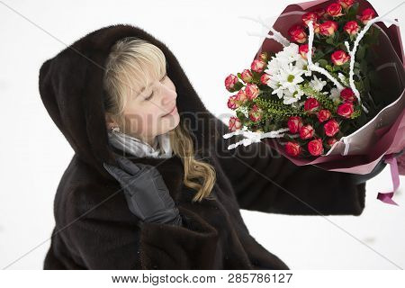 Happy Woman With A Bouquet Of Flowers