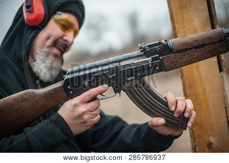 Close-up Detail View Of Kalashnikov Riffle Machine Gun Cartridge Bullet Clip Reloading. Load And Unl