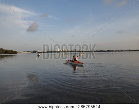 Key Biscayne, Florida 06-16-2018 Woman Kayaking In Early Morning On The Still Water Of Bear Cut With
