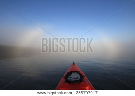Key Biscayne, Florida 01-16-2016 Red Kayak Heading Toward A Bright Fogbow Over Bear Cut Off Key Bisc