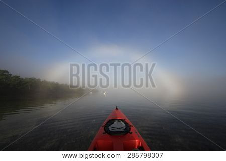 Key Biscayne, Florida 01-16-2016 Red Kayak Heading Toward A Bright Fogbow Over Bear Cut Off Key Bisc