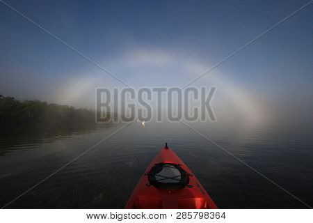 Key Biscayne, Florida 01-16-2016 Red Kayak Heading Toward A Bright Fogbow Over Bear Cut Off Key Bisc