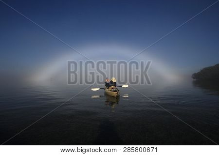 Key Biscayne, Florida 01-16-2016 Kayaker Enjoys A Bright Fogbow Ober Biscayne Bay On A Calm, Foggy M