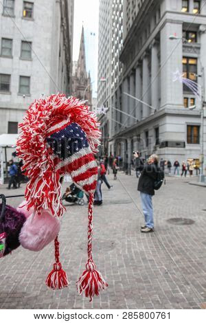 NEW YORK, NY - DECEMBER 01, 2014: Street souvenir`s  sale near Stock Exchange building with people on street and oher buildings around in New York City.
