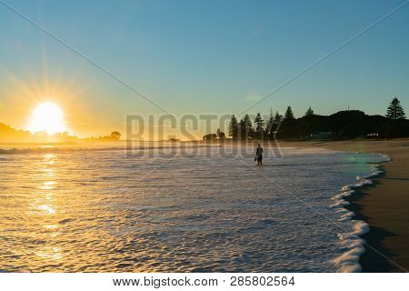 Mount Maunganui New Zealand February 11 2019; Small Unrecognizable Figure Of Woman Walking Away Into