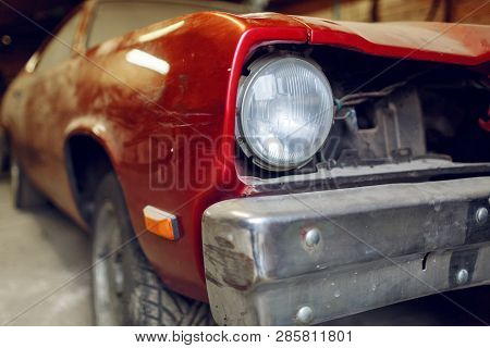 Restoration Of Classic Car. Close Up View Front Side Classic Car, Front Headlight Of A Broken Dusty 