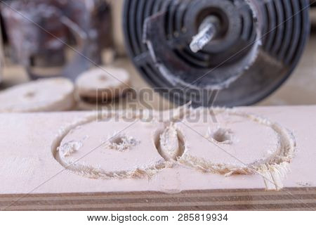 A device for making holes in wood. Joinery accessories for DIY enthusiasts. Dark background.