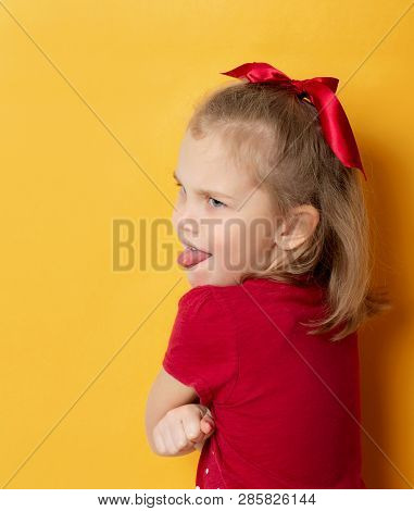 Emotional Little Girl Turned Her Back And Shows Her Tongue Out Over Her Shoulders. Insult And Upset,