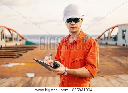 Chief Officer On Deck Of Ship Or Vessel With Checklist