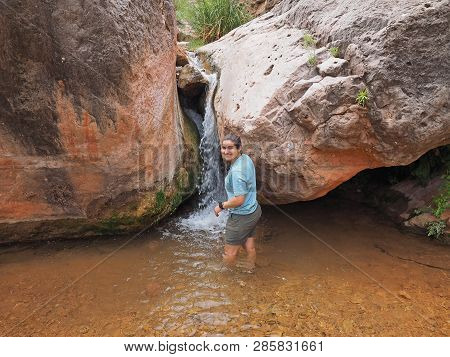 Young Woman Enjoys Some Downtime In Hermit Creek During A Multi-day Backpacking Expedition On The He