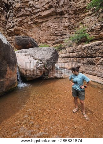 Young Woman Enjoys Some Downtime In Hermit Creek During A Multi-day Backpacking Expedition On The He