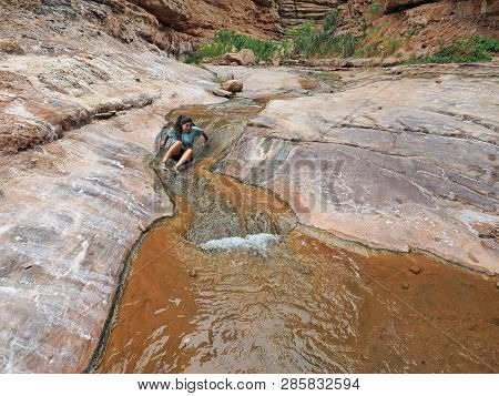 Young Woman Enjoys Some Downtime In Hermit Creek During A Multi-day Backpacking Expedition On The He