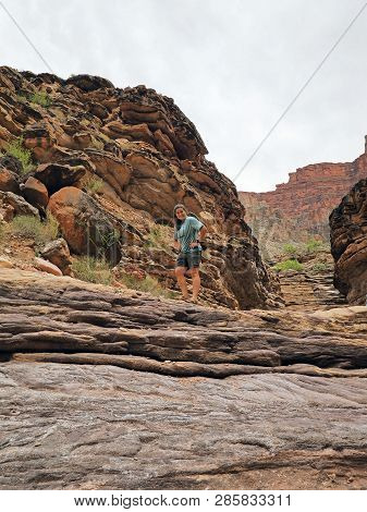 Young Woman Enjoys Some Downtime In Hermit Creek During A Multi-day Backpacking Expedition On The He