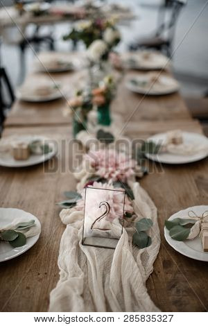 A Lots Of Cutlery And Some Decorations Are Laying At The Table Alongside With A Number 2 Sign.