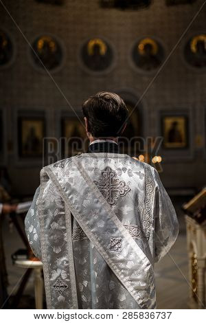 A Chaplain Is Standing In The Chapel During Wedding Ceremony. He Is Wearing A Silver Ceremonial Outf