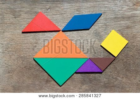 Color Tangram In Helicopter Shape On Wood Background