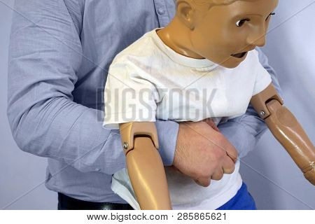 Abdominal Thrusts (the Heimlich Maneuver Or Heimlich Manoeuvre) On A Simulation Mannequin Child Dumm