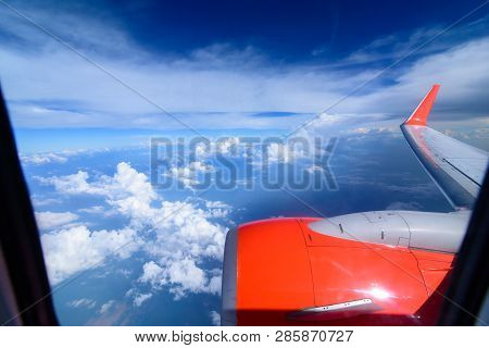 Arial View From Internal Cabin Of Aeroplane.clouds In The Sky And Cityscapes Though Airplane Window.