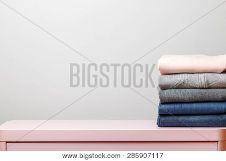 Cotton Stack Of Colorful Folded Clothes On White Table Indoors Empty Space Background.household Conc