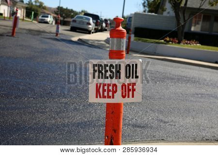 street repair. Fresh slurry or blacktop on surface streets. road work filling pot holes and cracks. fresh oil. 