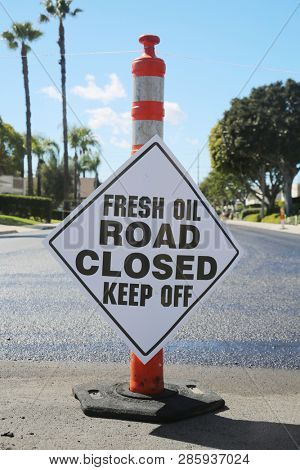 street repair. Fresh slurry or blacktop on surface streets. road work filling pot holes and cracks. fresh oil. 