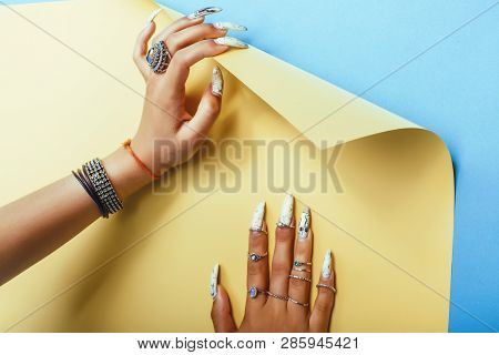 Woman Hands Holding Colorful Paper Copyspace Wearing A Lot Of Jewelry And Long Nails