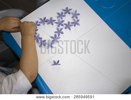 Child Makes A Postcard With A Picture 8 March. Kid Paperwork. Material For Creativity. Kindergarten.