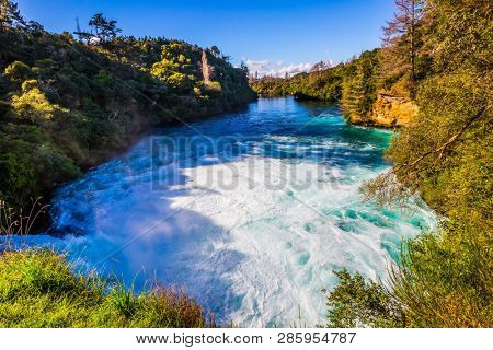 Powerful and buzzing Huka Falls. Summer sunny morning on the North Island, New Zealand. The concept of active, ecolgical and phototourism