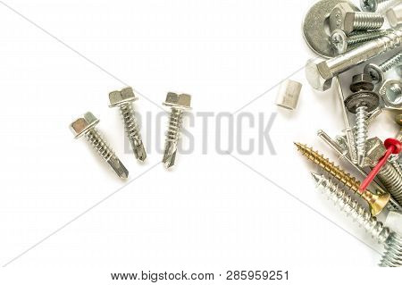 Flat Lay Of Self Drilling Screws For Roofing With A Drill And With Sealing Washer Isolated On White.