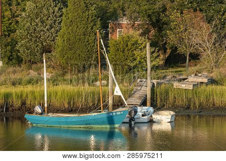 Wickford, Rhode Island, Usa - September 3, 2007: Small Boats At Small Dock On Marshy Shoreline In Wi