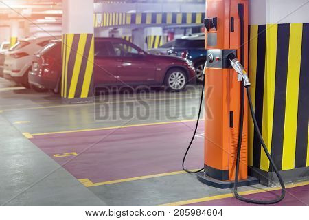 Electric Car Fast Charging Station At Indoor Underground Parking. Power Supply Point Network For Hyb