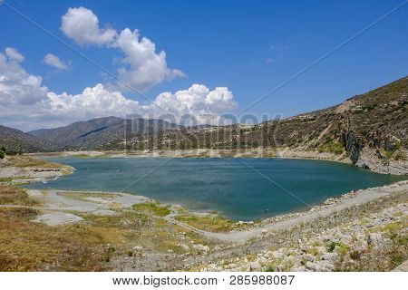 Scenic Landscape Shot Of Germasogeia Dam In Cyprus On A Beautiful Blue Sky Day.  Wind Patterns On Th