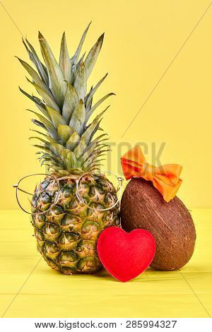 Pineapple, Coconut And Red Heart. Pinepple In Glasses, Coconut In Hair Bow On Color Background. Love