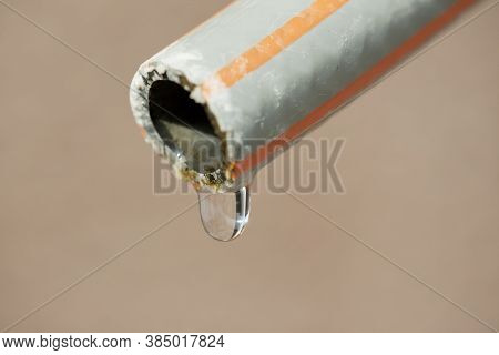 Close-up Of A Water Drop Dripping Out Of A House In A Dry Environment - Selective Focus