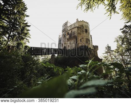 Burg Grimmenstein Castle In Lower Austria Framed By Green Leaves