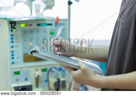 The specialist are checking continuous renal replacement therapy equipment and injection pump and he