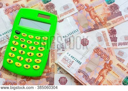 Green Calculator And A Bunch Of Five Thousandth Bills