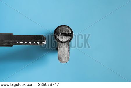 A Door Lock Cylinder Core With Key On The Blue Background. The Cylinder Of The Lock With Key. Instal