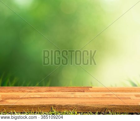 Blank Wood Board With Blur Green Courtyard Background.summer And Picnic Concepts.design For Key Visu