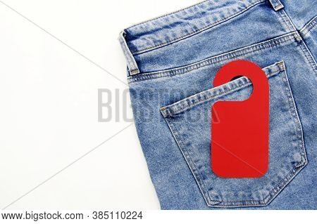 Blue Jeans With A Selling Red, Paper Price Tag In The Pocket On A White Background. The Concept Of S