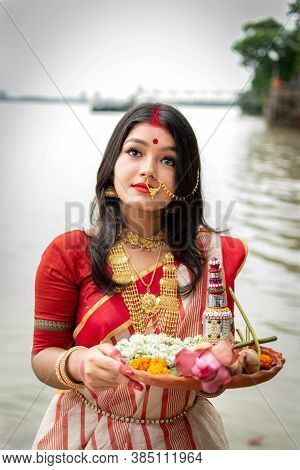 Portrait Of Beautiful Indian Girl Standing In Front Of Ganga River Wearing Traditional Indian Saree,