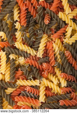 Raw Homemade Tricolore Fusilli Pasta As Texture Background. Top View