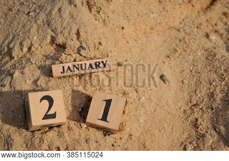 January 21, Number Cube With A Sand Background.