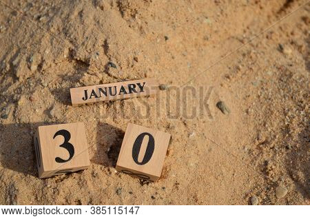 January 30, Number Cube With A Sand Background.