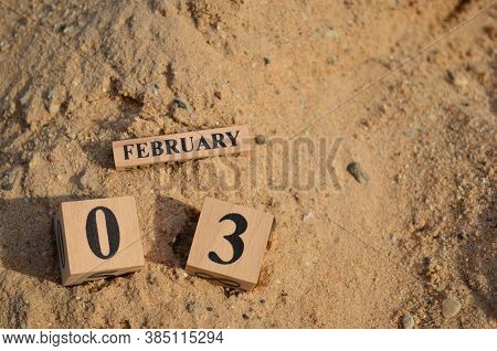 February 3, Number Cube With A Sand Background.
