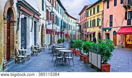 Charming streets with bars in narrows alleys of italian towns. Montalcino in Tuscany. Italy