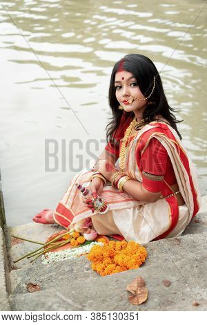 Portrait Of Beautiful Indian Girl In Front Of Ganga River Wearing Traditional Indian Saree, Gold Jew