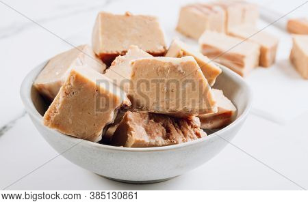 Raw Vegan Peanut Butter Fudge On A White Marble Background.
